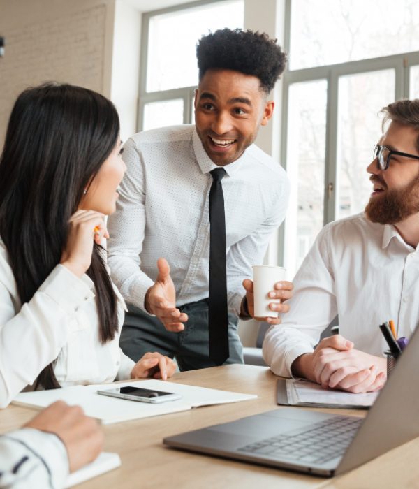 cherful-positive-young-colleagues-using-laptop-computer